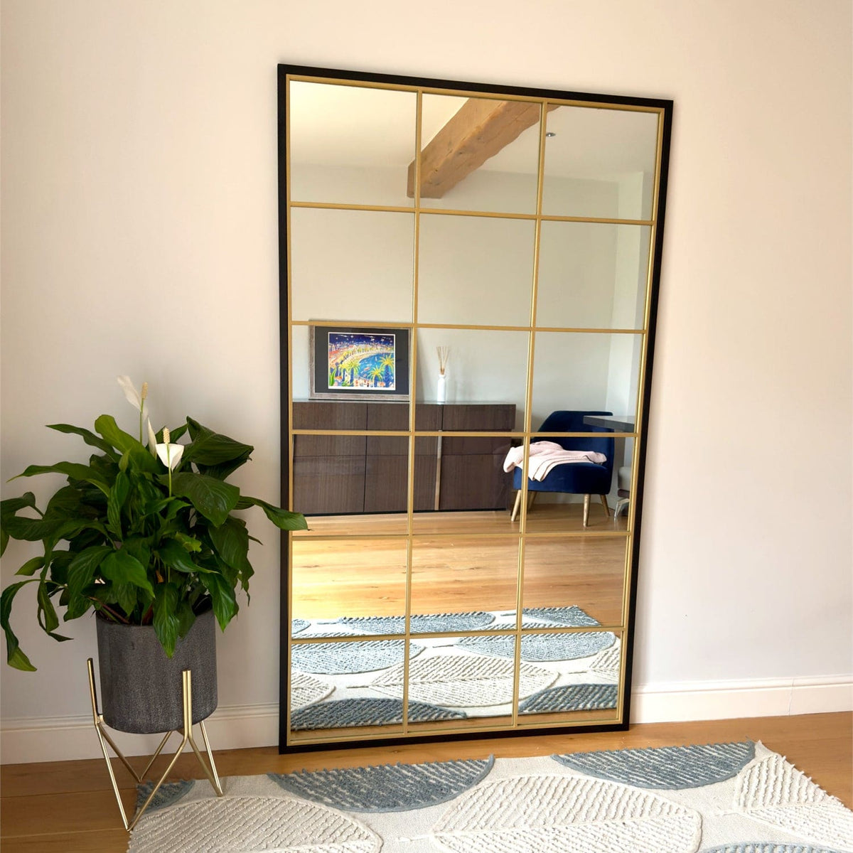 Elegant Grid Mirror by Jobu Home with a sleek black frame and gold grid design