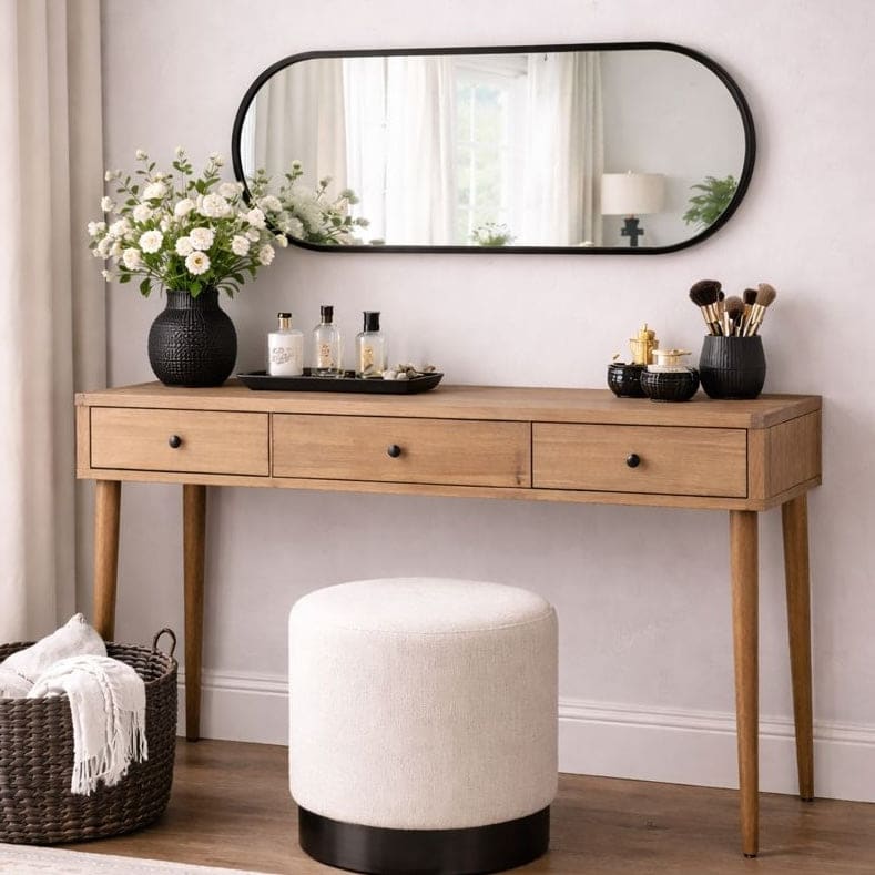 Jobu Home Oval Mirror above a wooden console table decorated with flowers and accessories