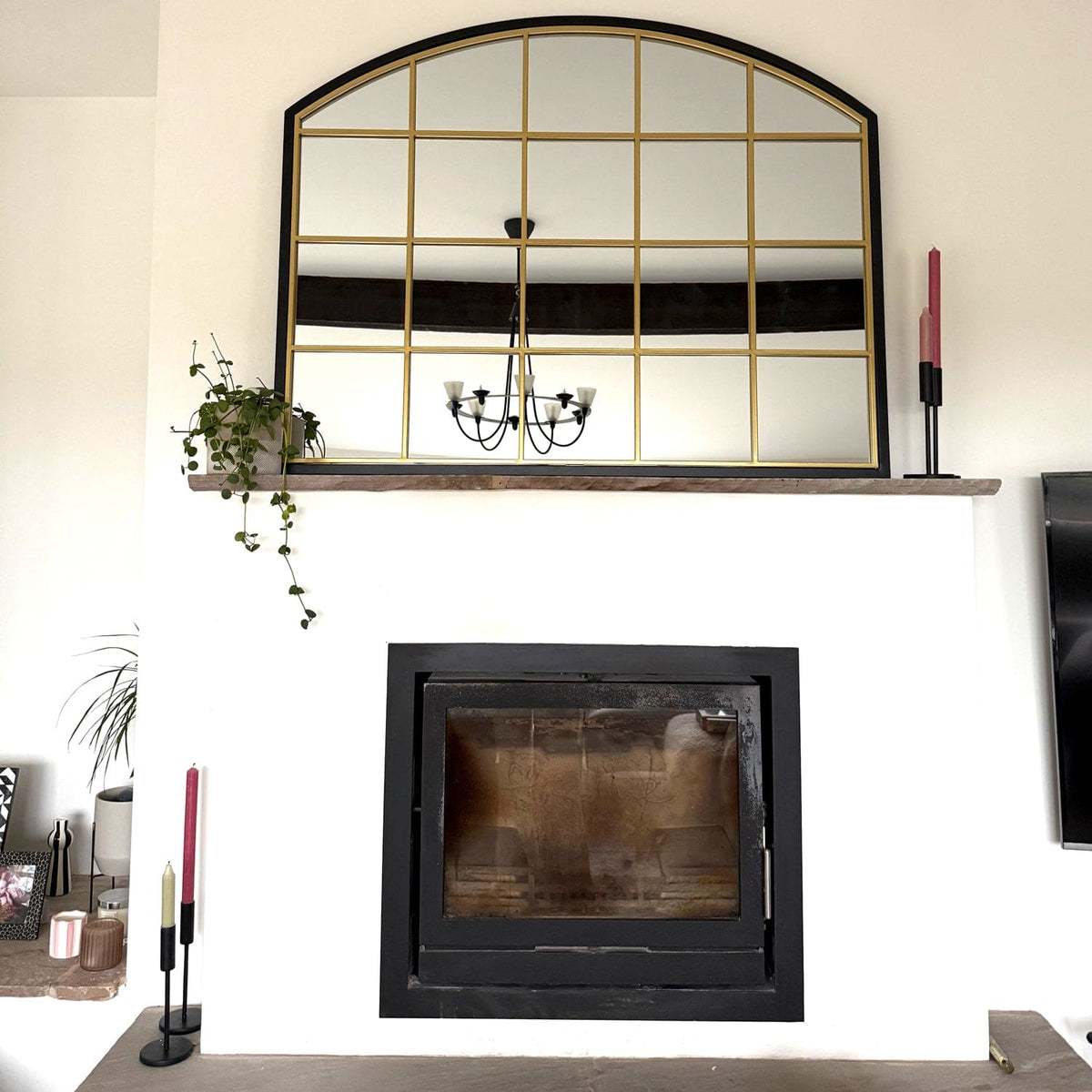 Jobu Home Window Mirror with an elegant arched design above a decorative fireplace