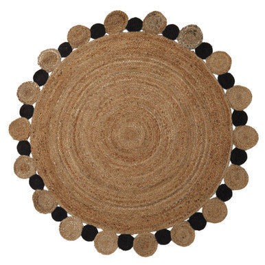 Orsina Jute Rug in a round shape with contrasting black pom-poms for a stylish natural decor