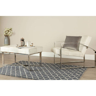 Orsina Lattice Rug featuring a geometric design, placed under a modern coffee table and chair