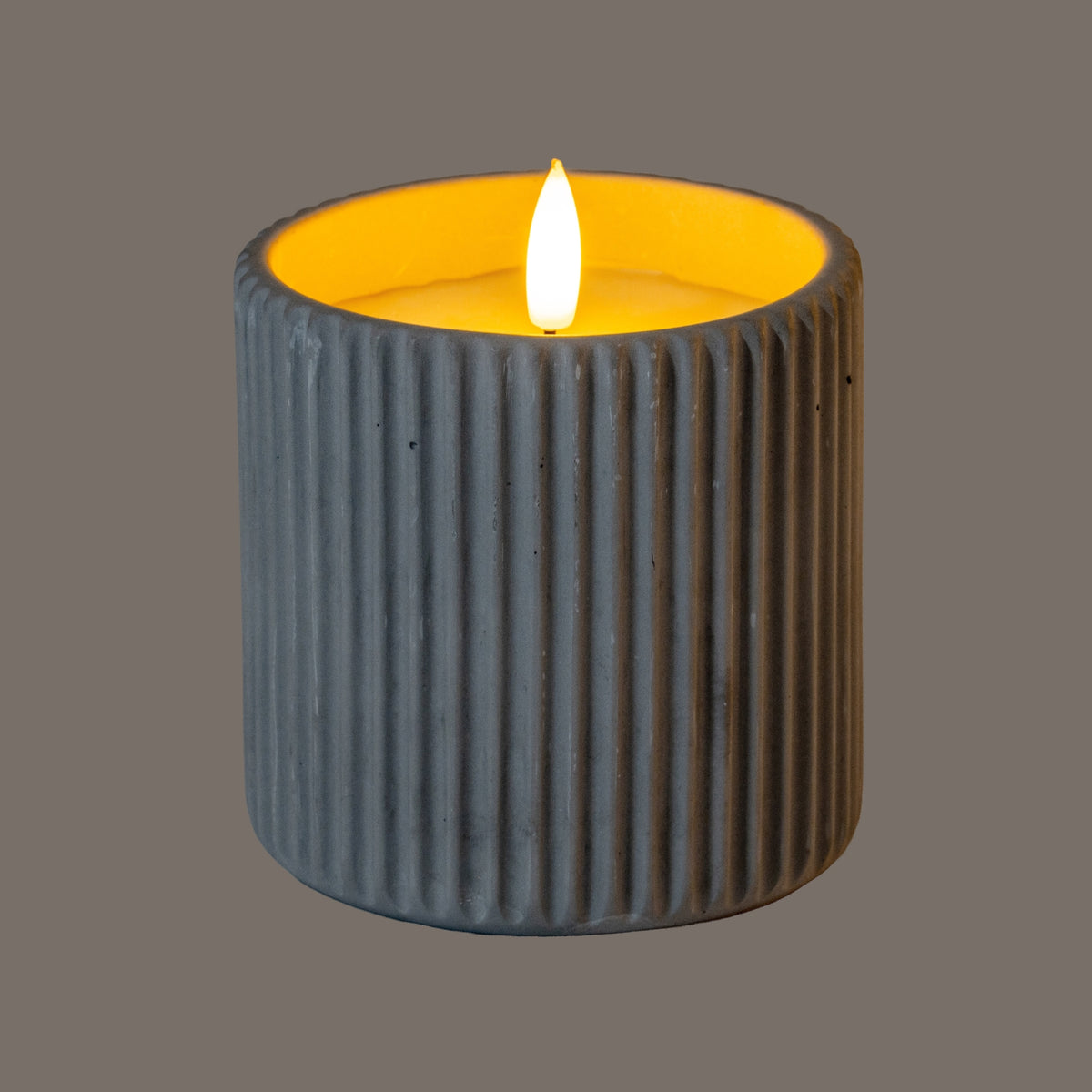 LED Candle in a textured grey holder providing a warm ambient glow for home decor