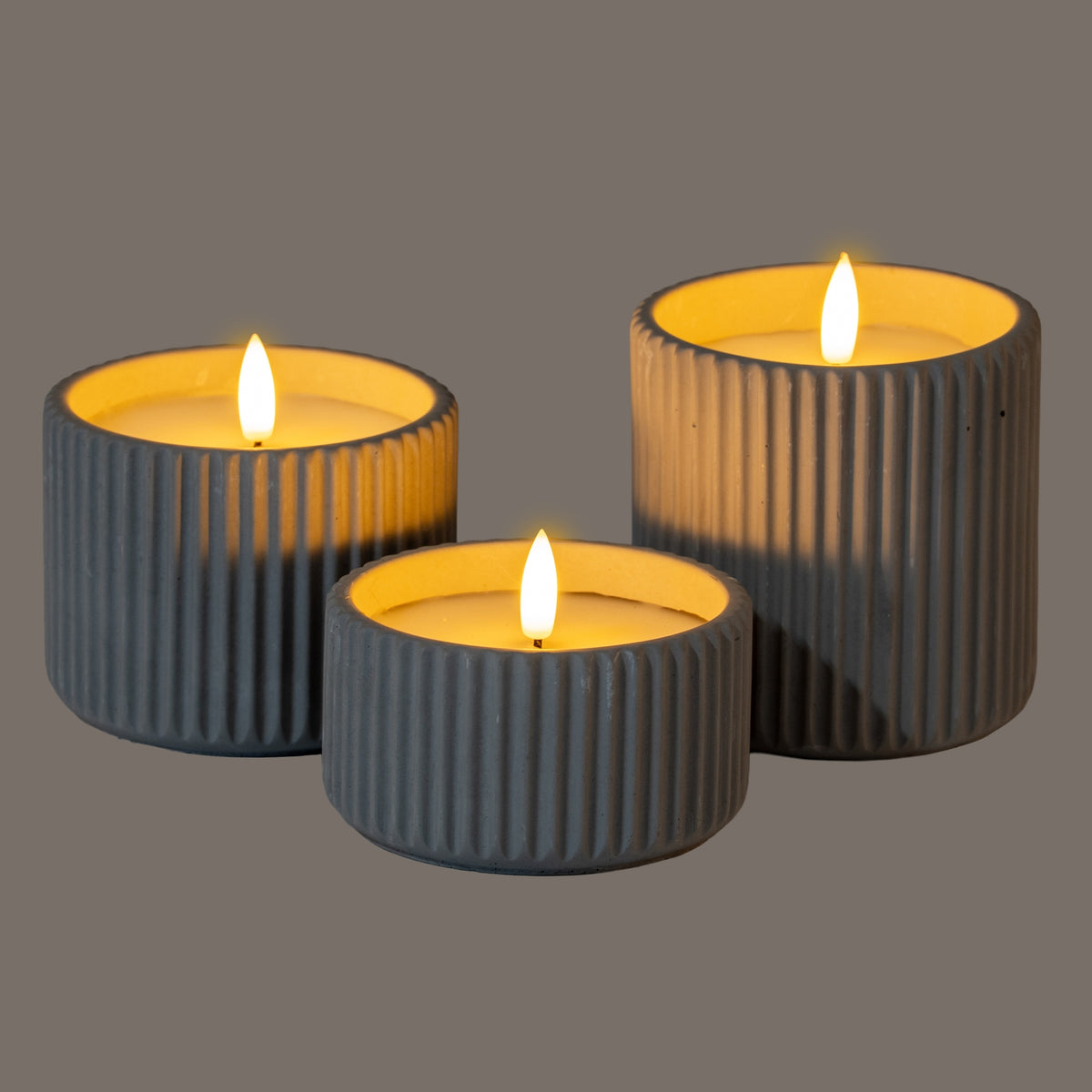 Set of three grey ribbed LED Candles with warm flickering light for a calming ambiance