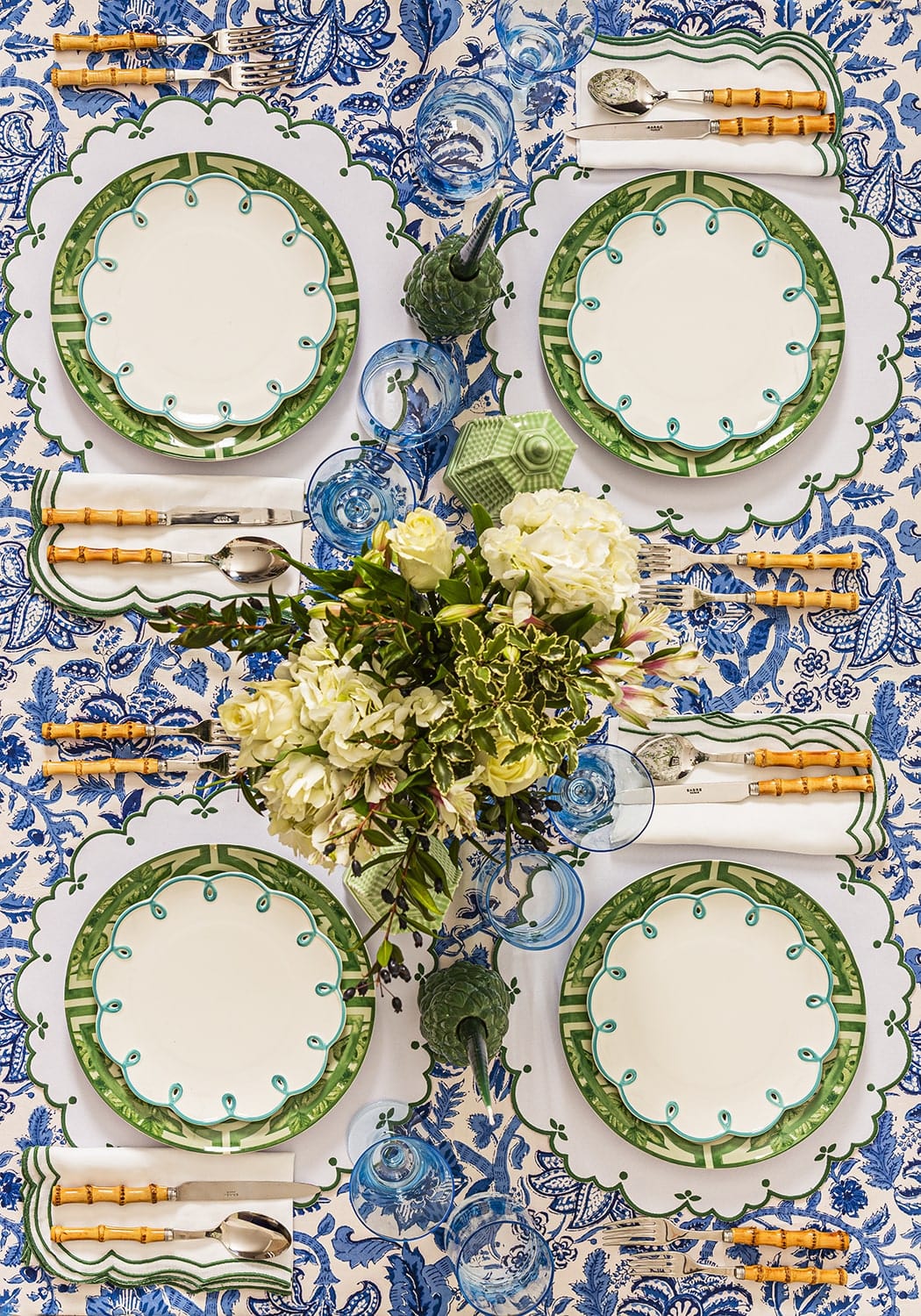 Casa by Josephine Jenno Lunch Plate in green design set on a floral tablecloth with cutlery and flowers