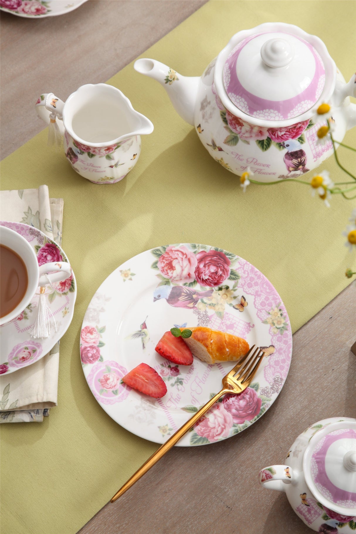 Elegant floral Milk Jug on a table setting with tea, strawberries, and a decorative plate