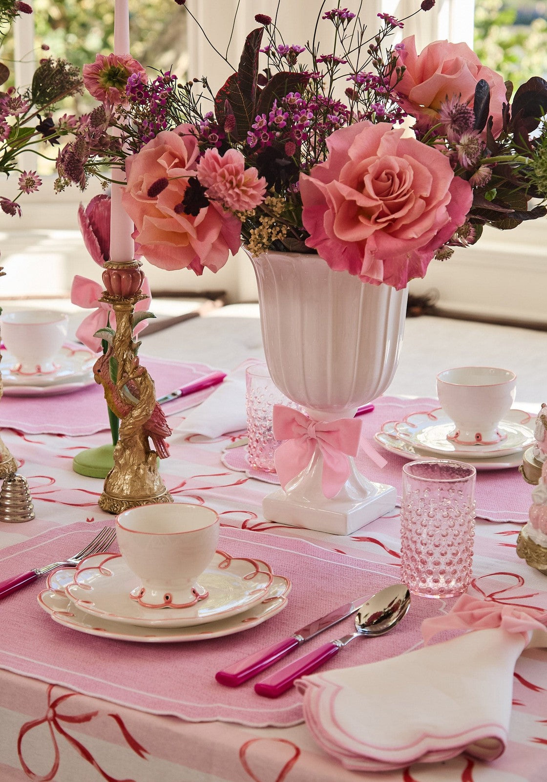 Elegant dining setup featuring a Casa by Josephine Jenno Nibbles Bowl surrounded by floral decorations