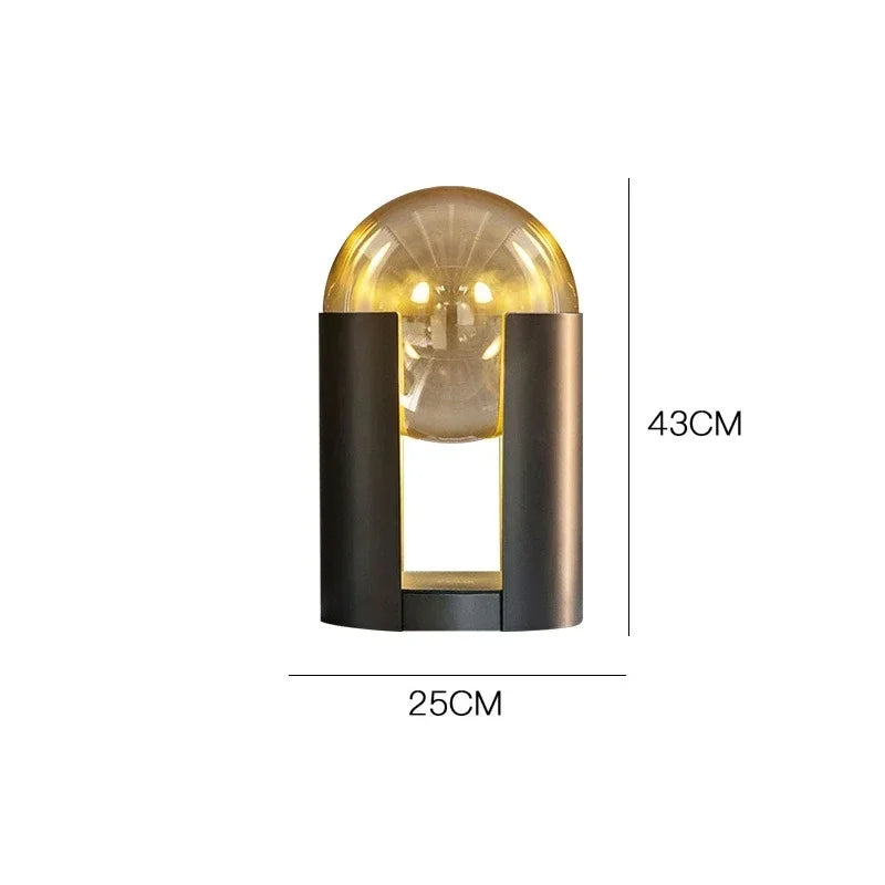 Norda Lamp with a contemporary design featuring a round glass bulb and sleek metal base, measuring 43cm by 25cm