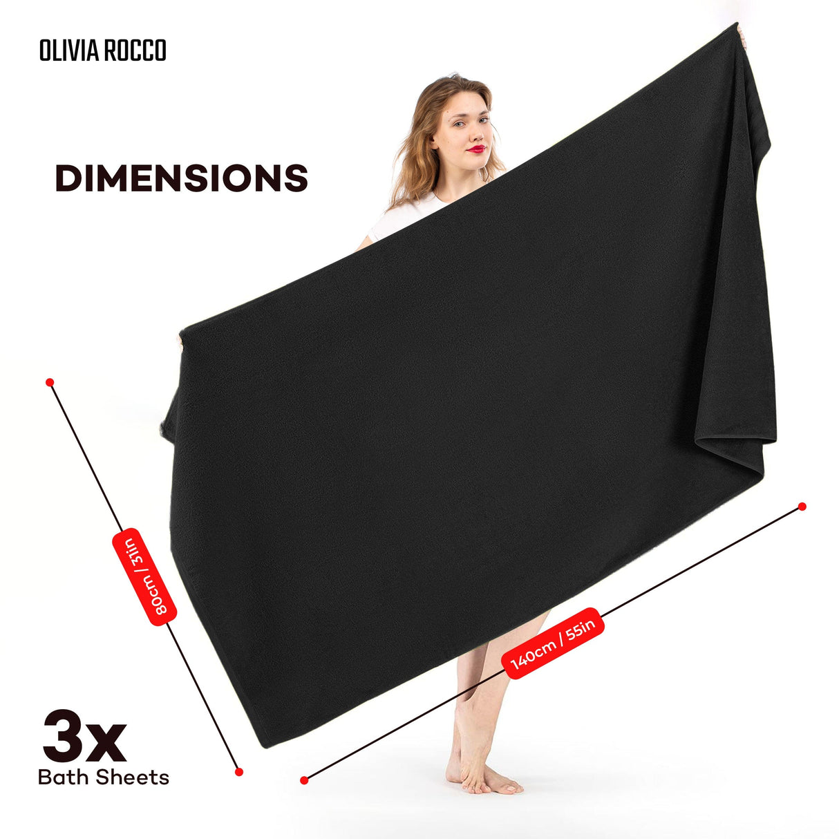 Olivia Rocco black bath sheets held by a model, showcasing their large size and soft fabric
