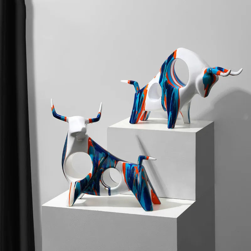 Colourful decorative cow ornaments in blue and orange from Nisu Home for stylish interior accents