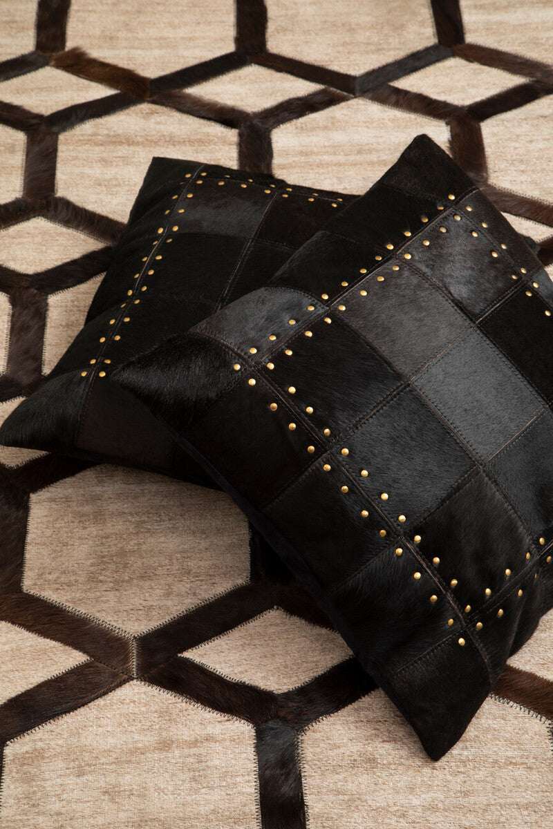 Orsina Patchwork Cushion in black leather with decorative gold studs for elegant home decor