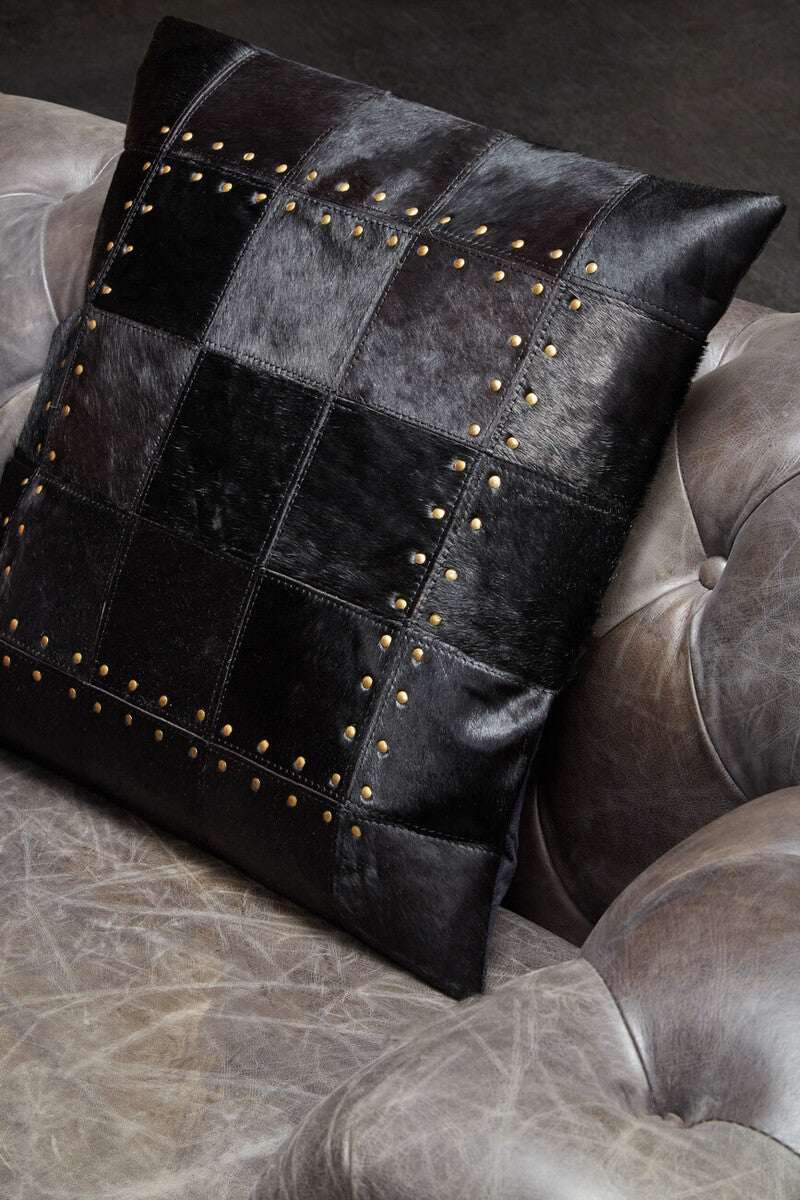 Stylish Patchwork Cushion in black leather with studded details, perfect for sofa decor
