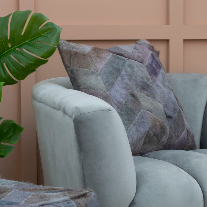 Orsina Patchwork Cushion in soft tones, adding a stylish touch to modern seating