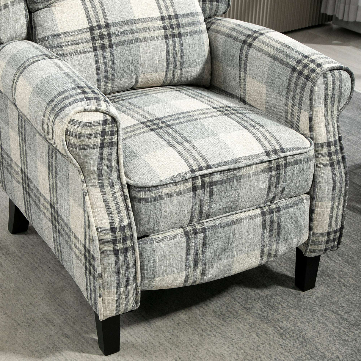 Comfortable grey and white checked reclining armchair with plush cushions for relaxation