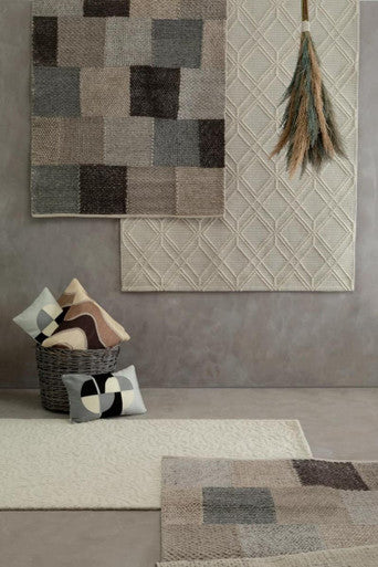 Orsina Rectangular Cushion in various designs displayed with rugs and a basket for home decor