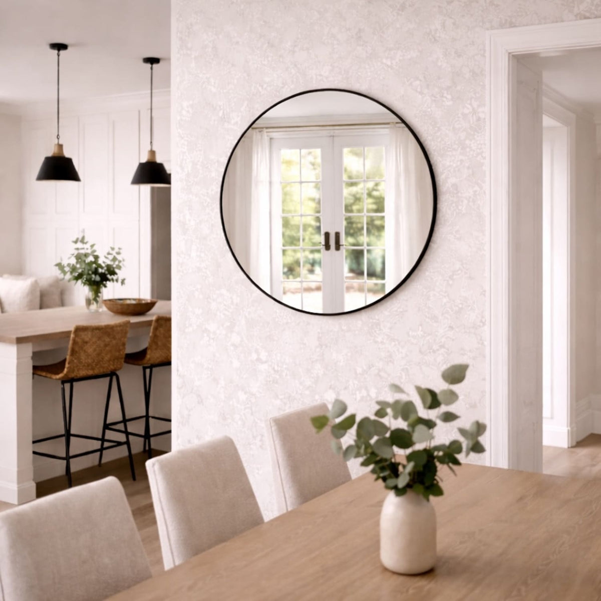 Jobu Home Circle Mirror with a sleek black frame, enhancing a modern dining space