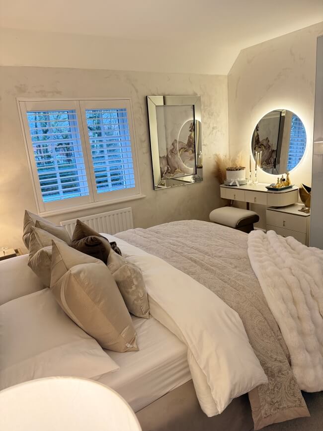 Stylish Round Mirror above a vanity in a modern bedroom with elegant decor