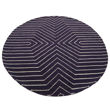 Orsina Round Rug featuring a modern geometric pattern in navy blue and white stripes