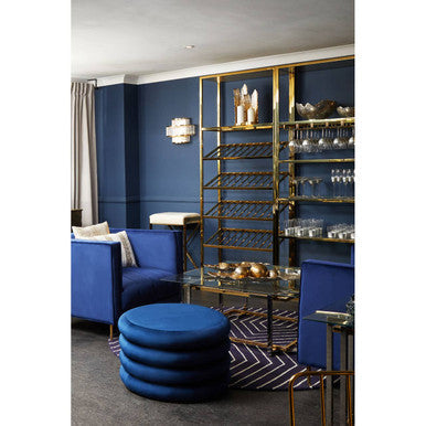 Elegant blue Orsina round rug complementing a stylish living room with plush seating