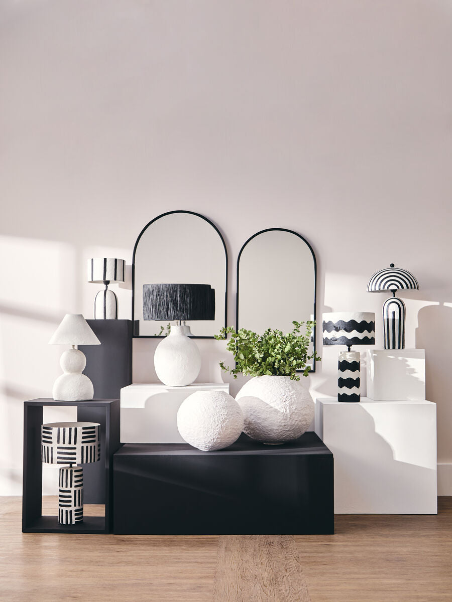 Elegant round vase displayed among modern decorative items and plants in a stylish living space