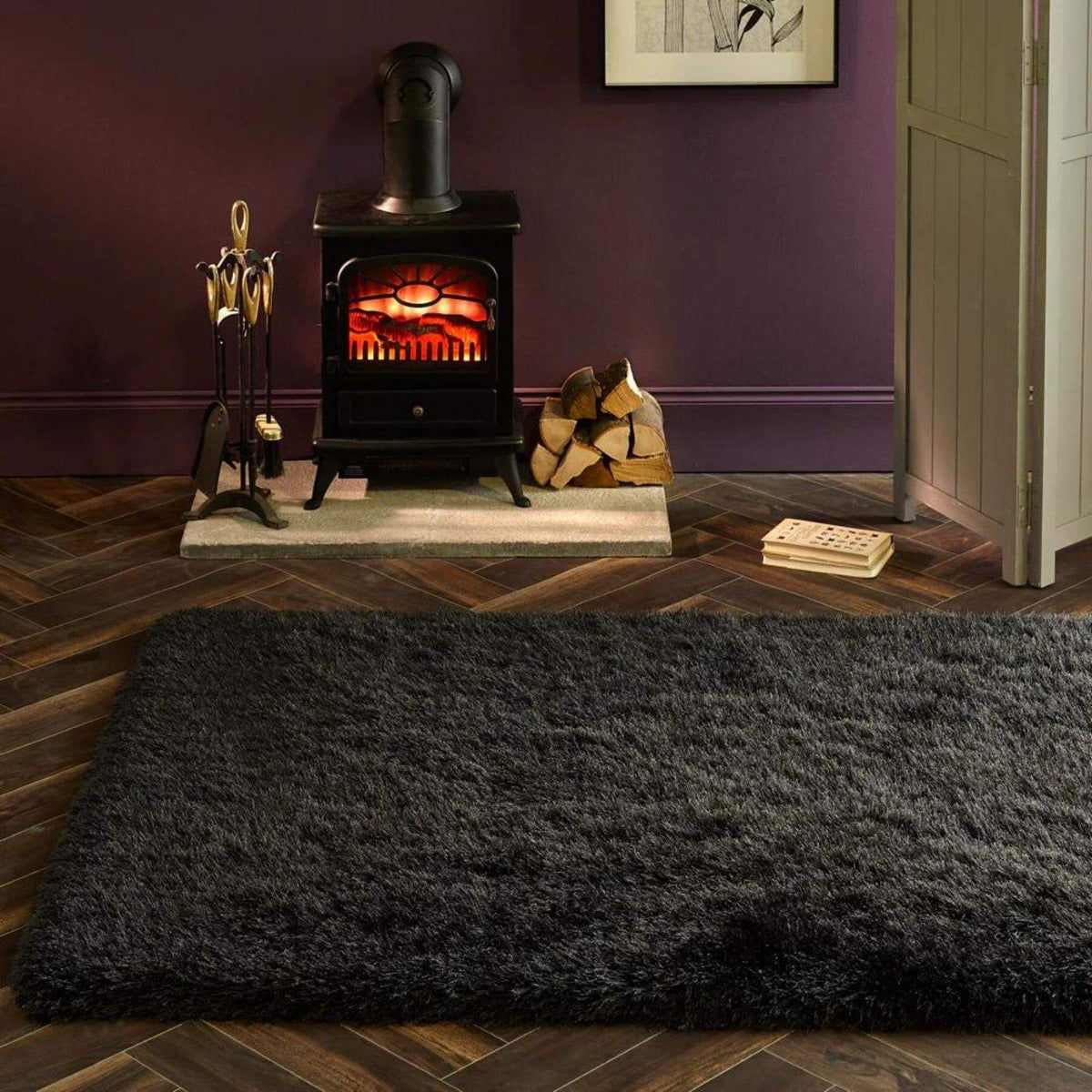 Luxurious black shaggy rug enhancing a cosy living room with a fireplace and wooden flooring