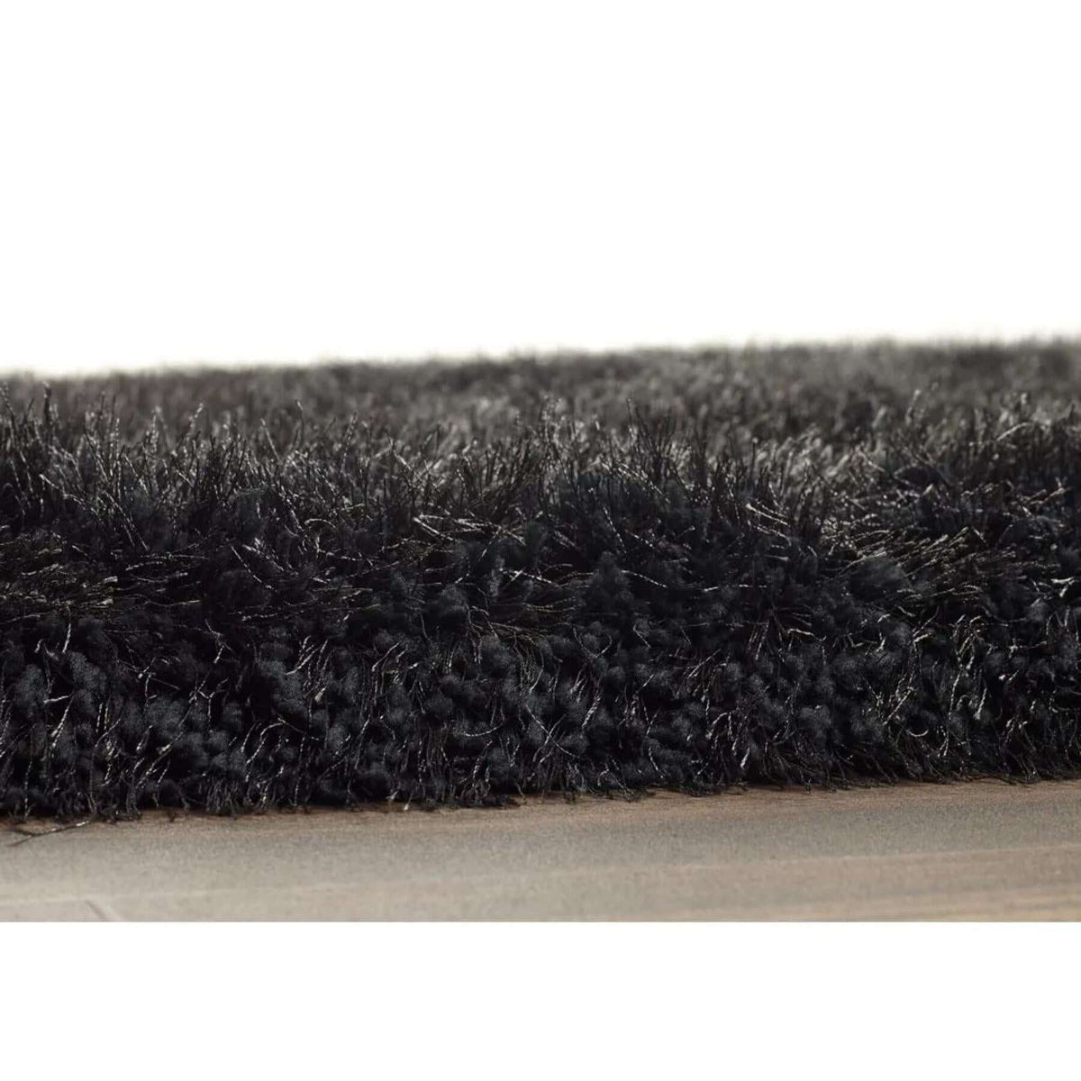Close-up of a soft black shaggy rug with a plush texture for a cosy home decor