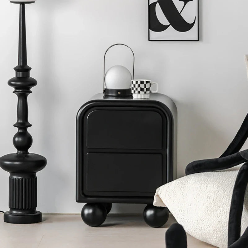 Modern black side table by Nisu Home with rounded corners and stylish design in a chic living room setting