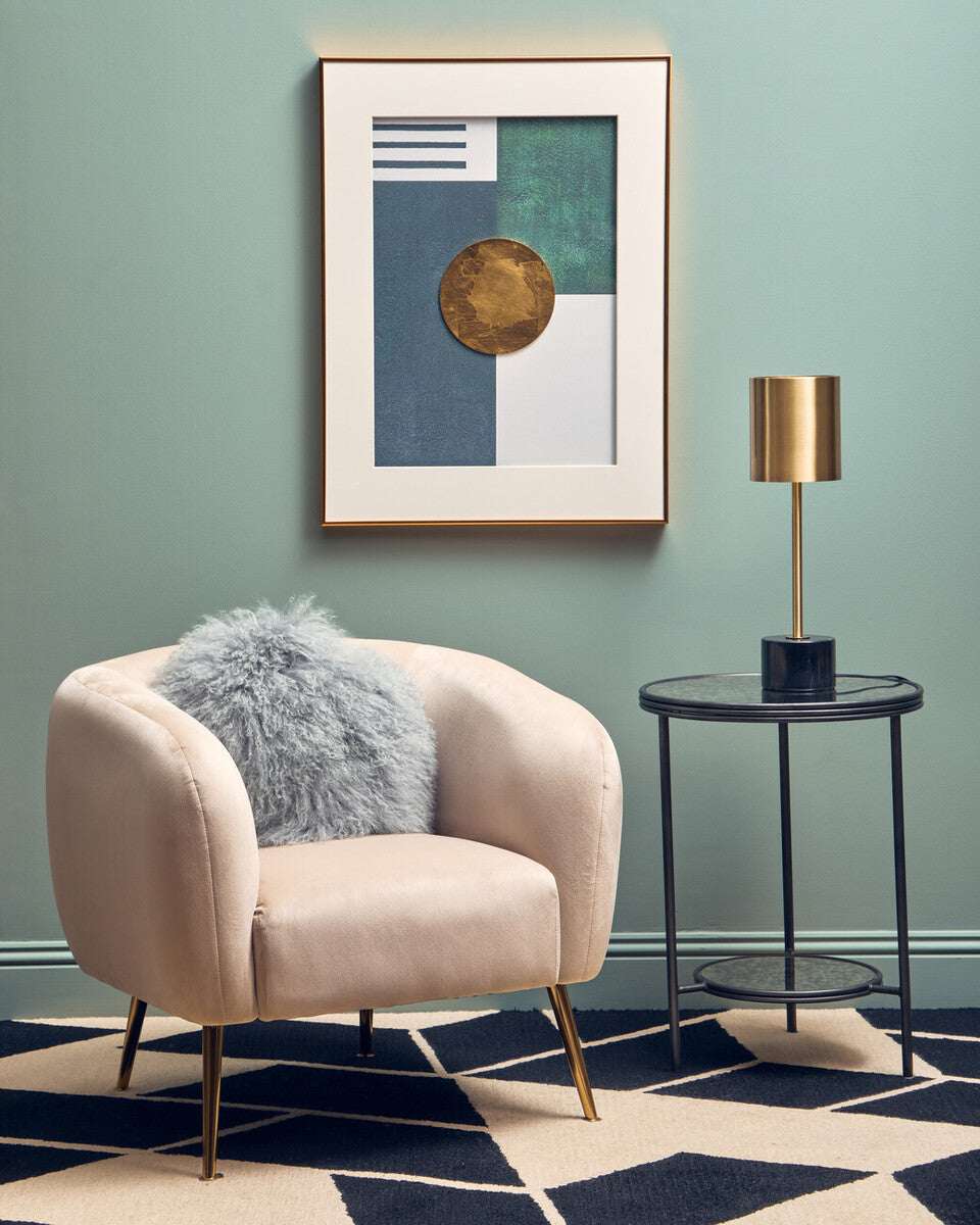 Stylish Orsina Side Table in a modern living room setting with a lamp and decorative chair