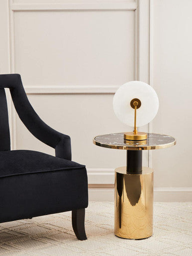 Orsina side table with a round marble top and gold base, paired with a stylish lamp