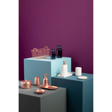 Orsina Soap Dish displayed among stylish bathroom accessories on geometric pedestals