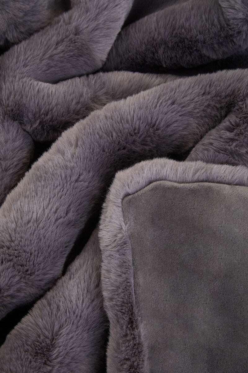 Soft and plush grey Orsina Fur Throw, perfect for adding warmth and style to any living space