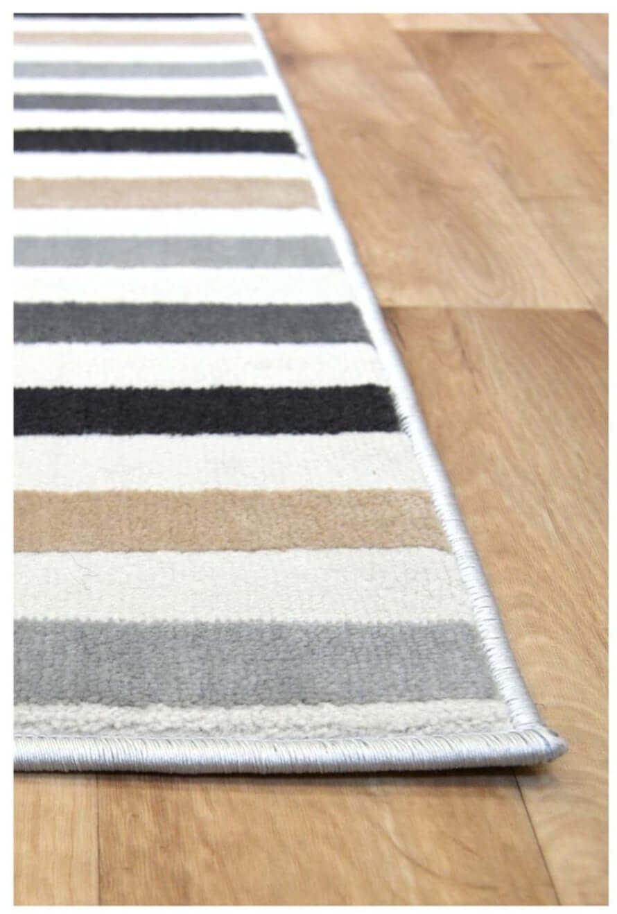 Stripe Rug in neutral tones featuring soft texture on a wooden floor