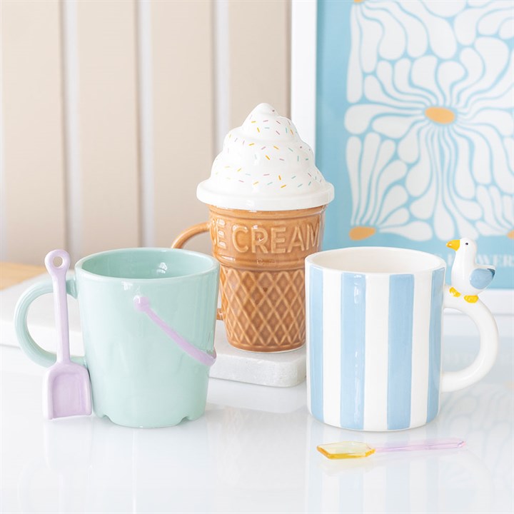 Set of three ceramic mugs including a striped mug, perfect for stylish beverage enjoyment