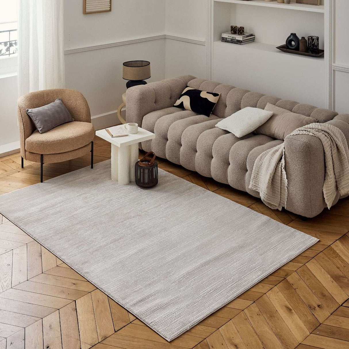 Neutral Striped Rug placed elegantly under a stylish sofa in a modern living room