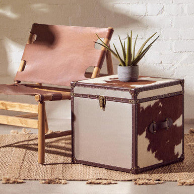 Orsina Striped Rug under a chair and storage box, adding warmth to the modern decor