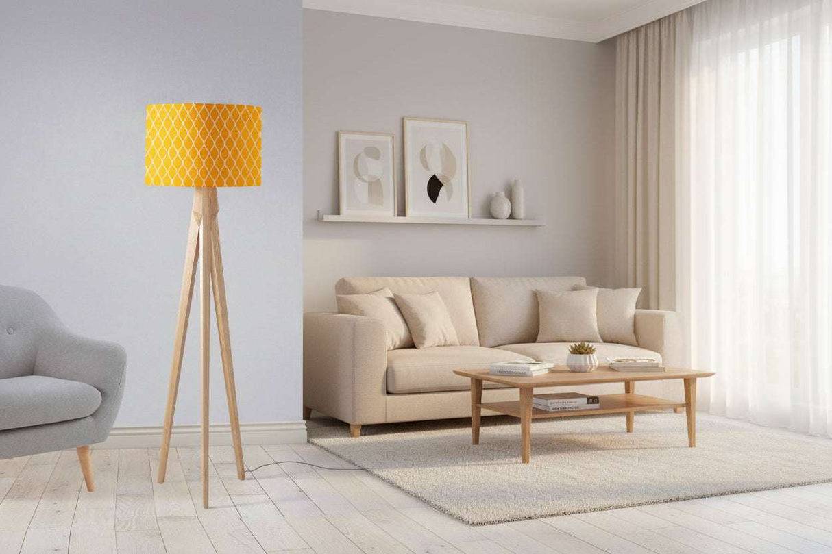 Modern lampshade in yellow patterned design on a stylish floor lamp in a bright living room