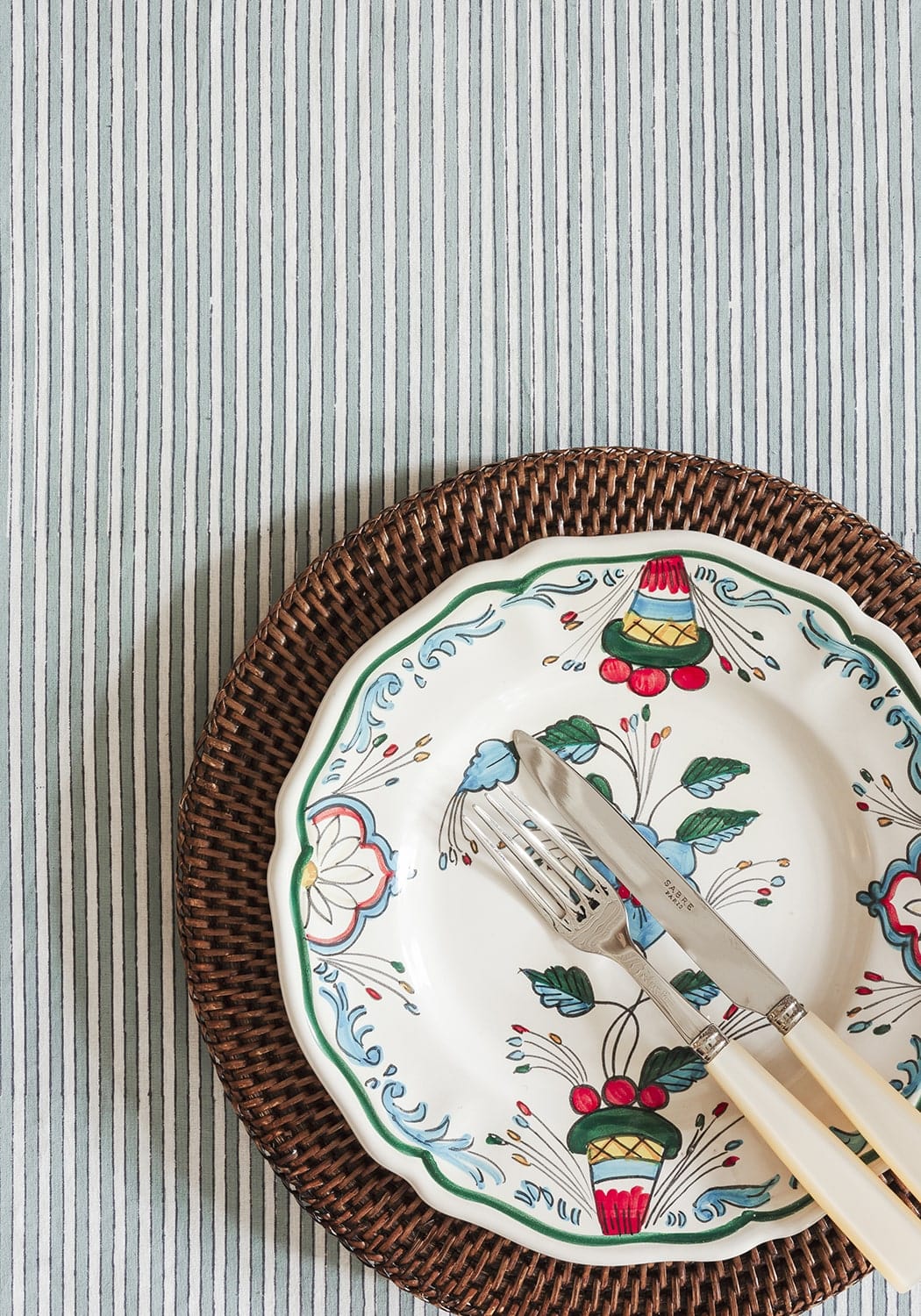 Casa by Josephine Jenno striped Tablecloth with decorative plates and cutlery on top