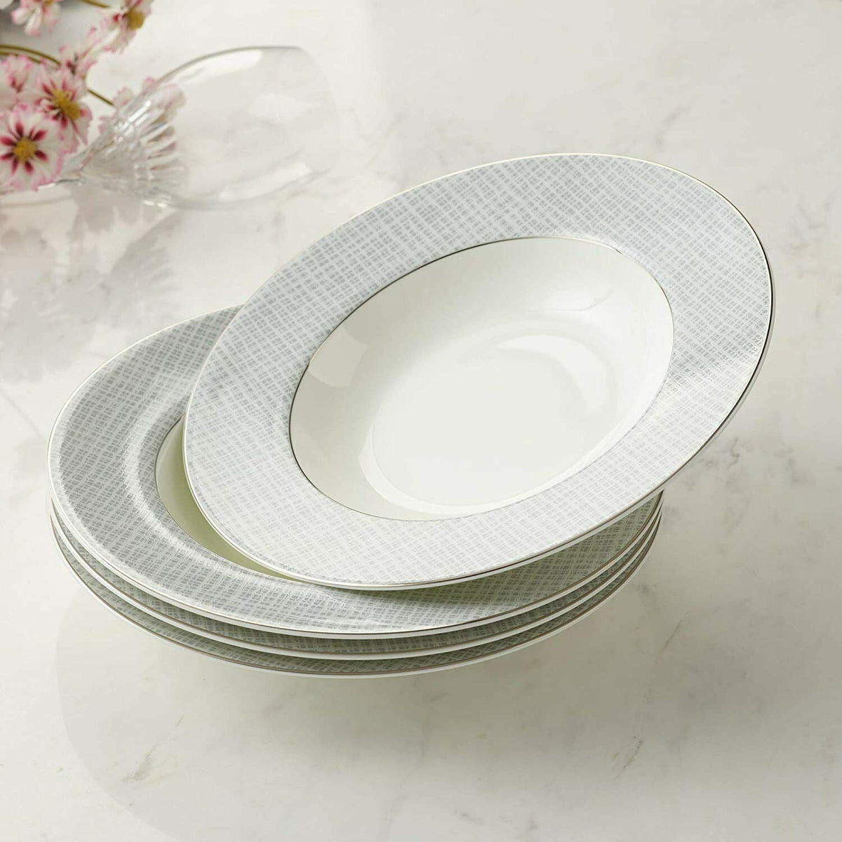 Set of four elegant soup bowls with a fine grey pattern and gold rim detailing