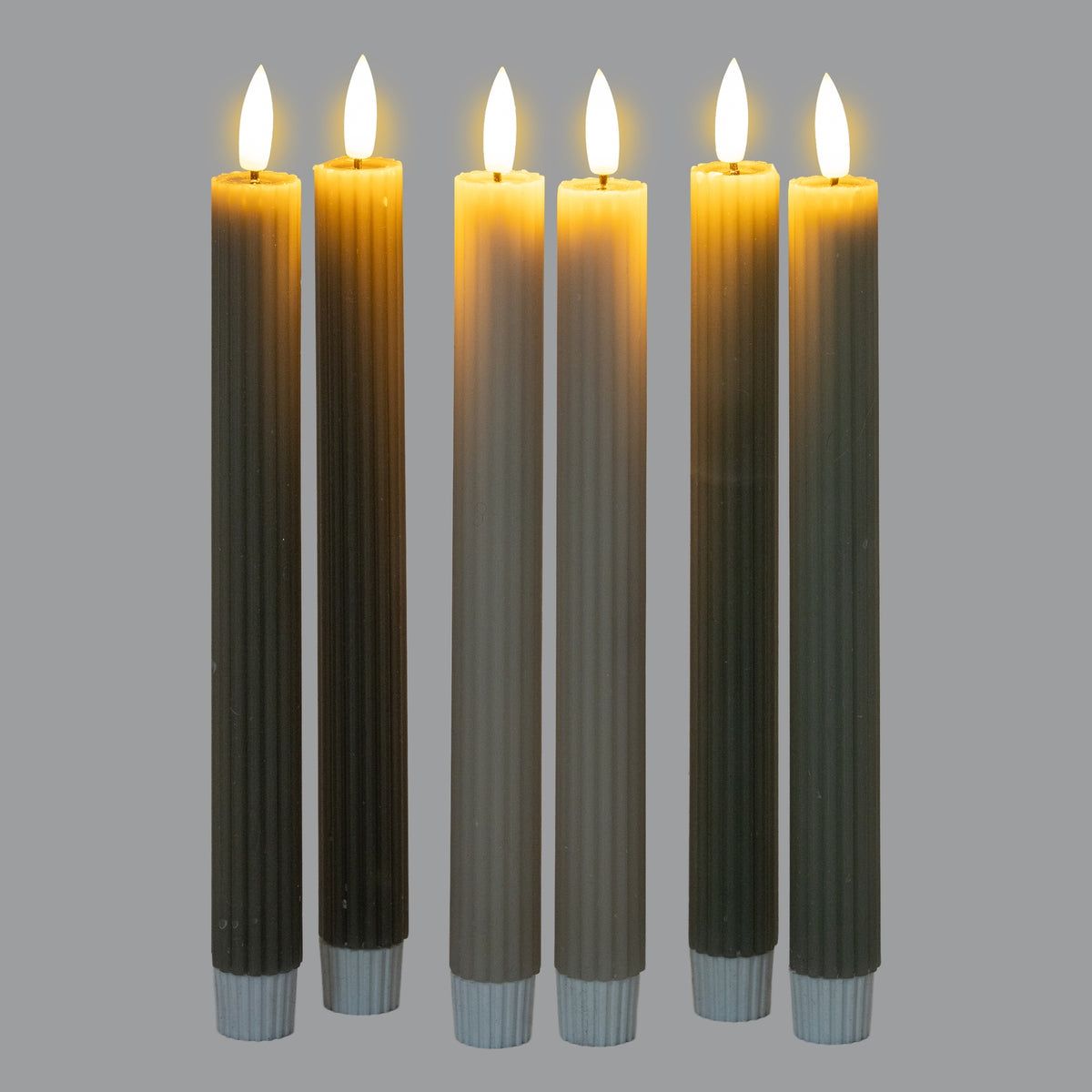 Set of six Shades 4 Seasons taper candles in various earthy colours with warm flickering flames