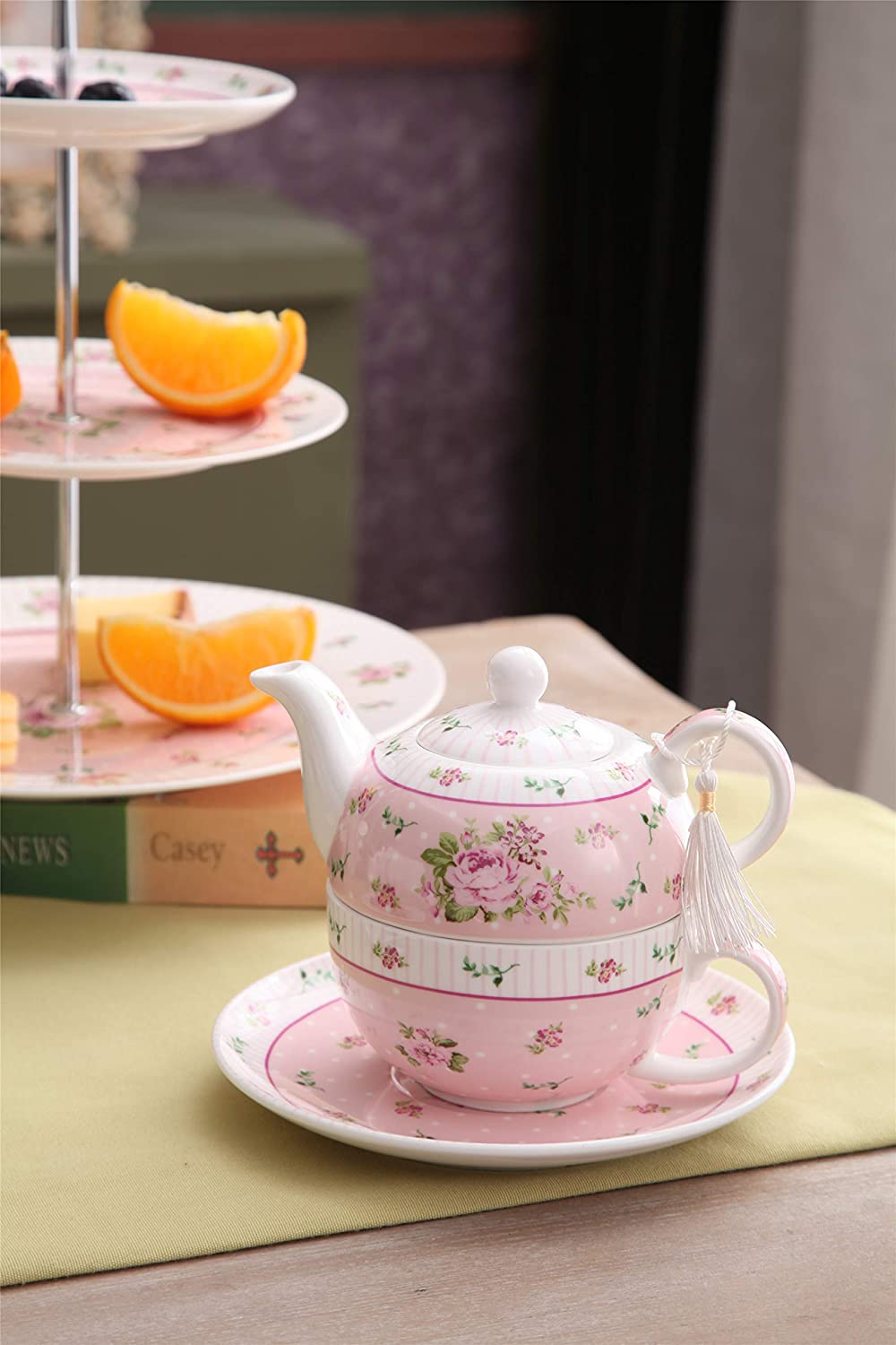 Elegant pink floral tea set with teapot and matching cup, perfect for afternoon tea