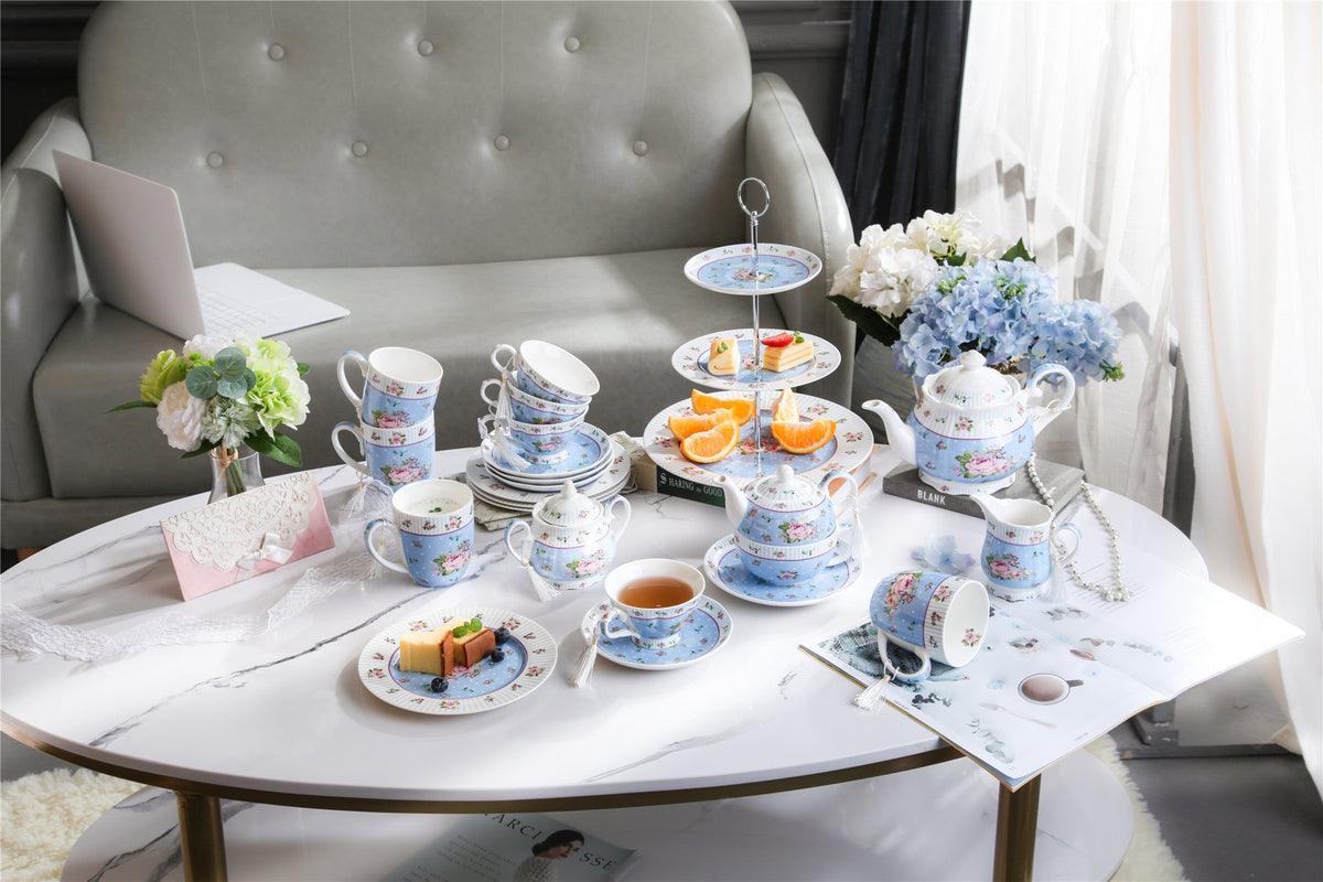Elegant tea set display featuring a Sugar Bowl and assorted pastries on a stylish coffee table