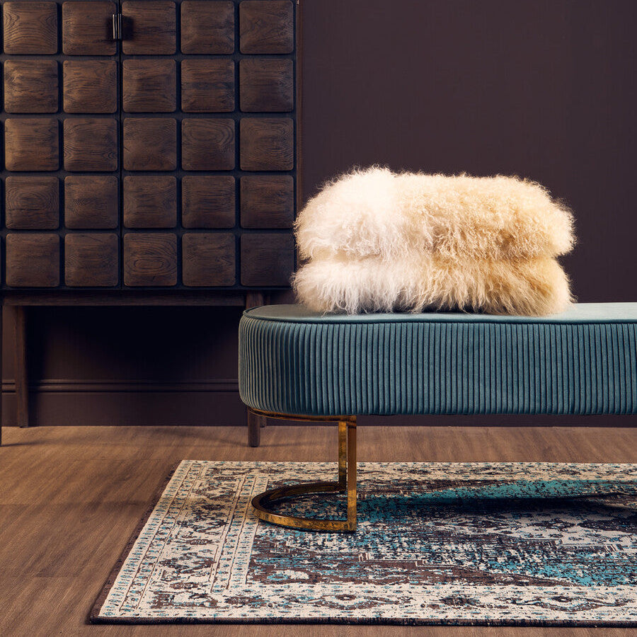 Orsina Teal Rug with Intricate Patterns, placed under a stylish seating area