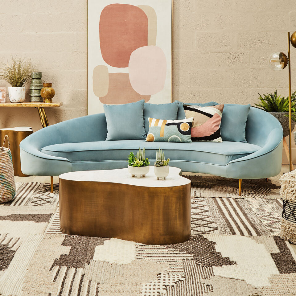 Stylish Orsina Textured Rug featuring geometric patterns under a modern curved sofa
