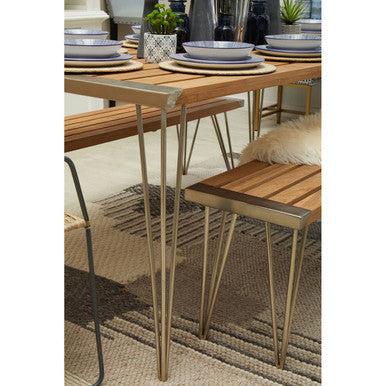 Orsina Textured Rug in a modern dining setting with wooden table and stylish tableware