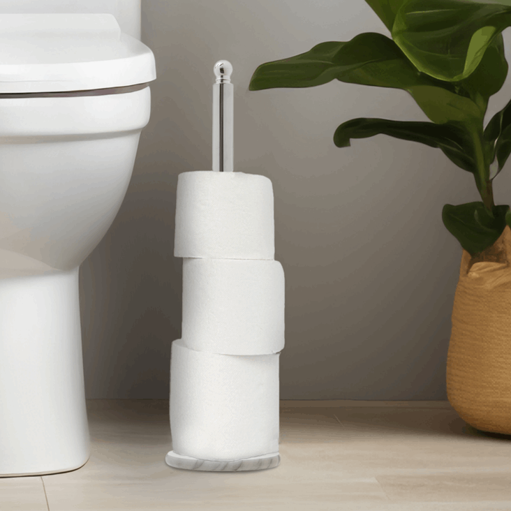 Orsina Toilet Roll Holder with a sleek design, stylishly displaying three rolls beside a modern toilet