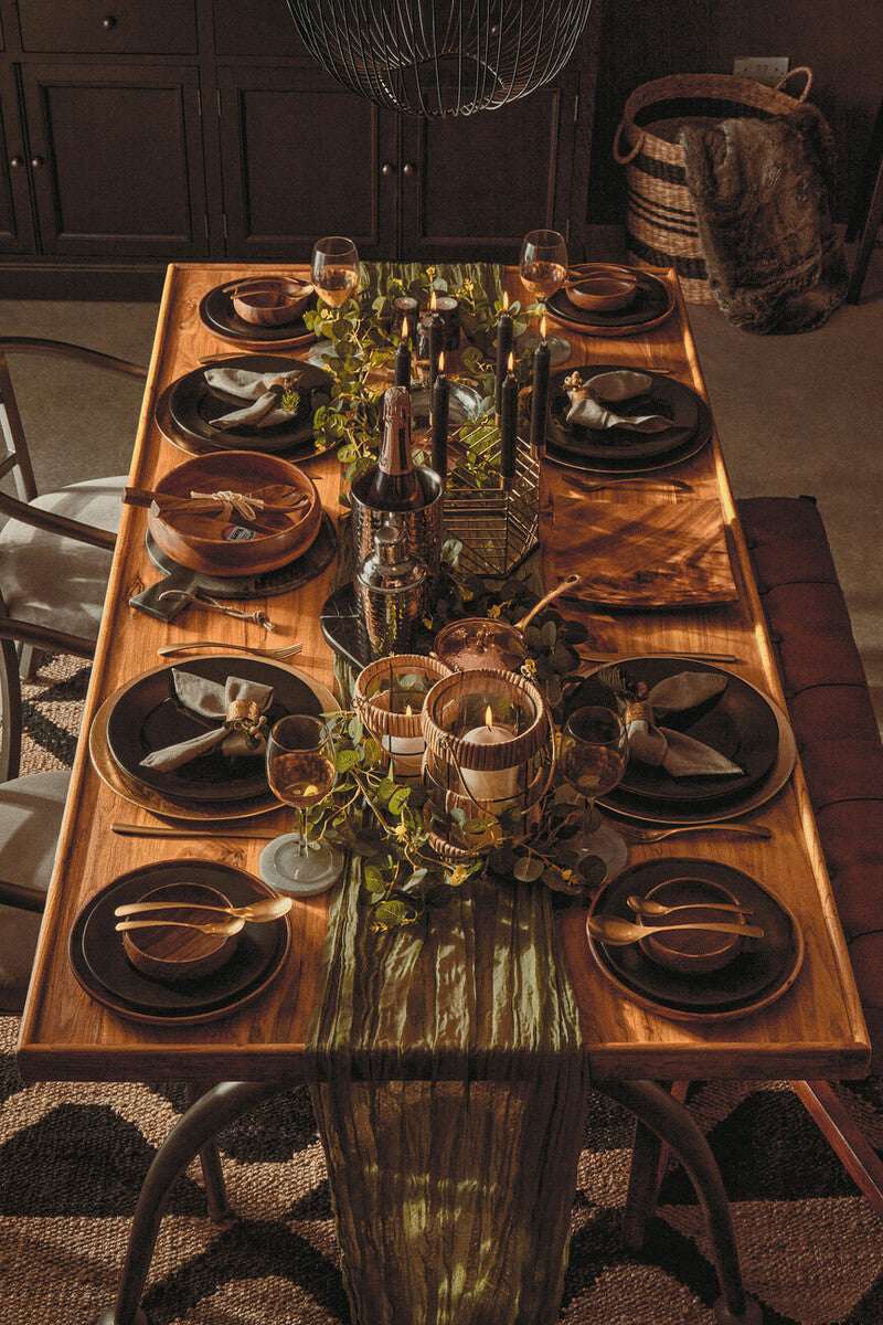 Stylish dining table decorated with a Hemp Rug, elegant tableware, and ambient lighting for gatherings