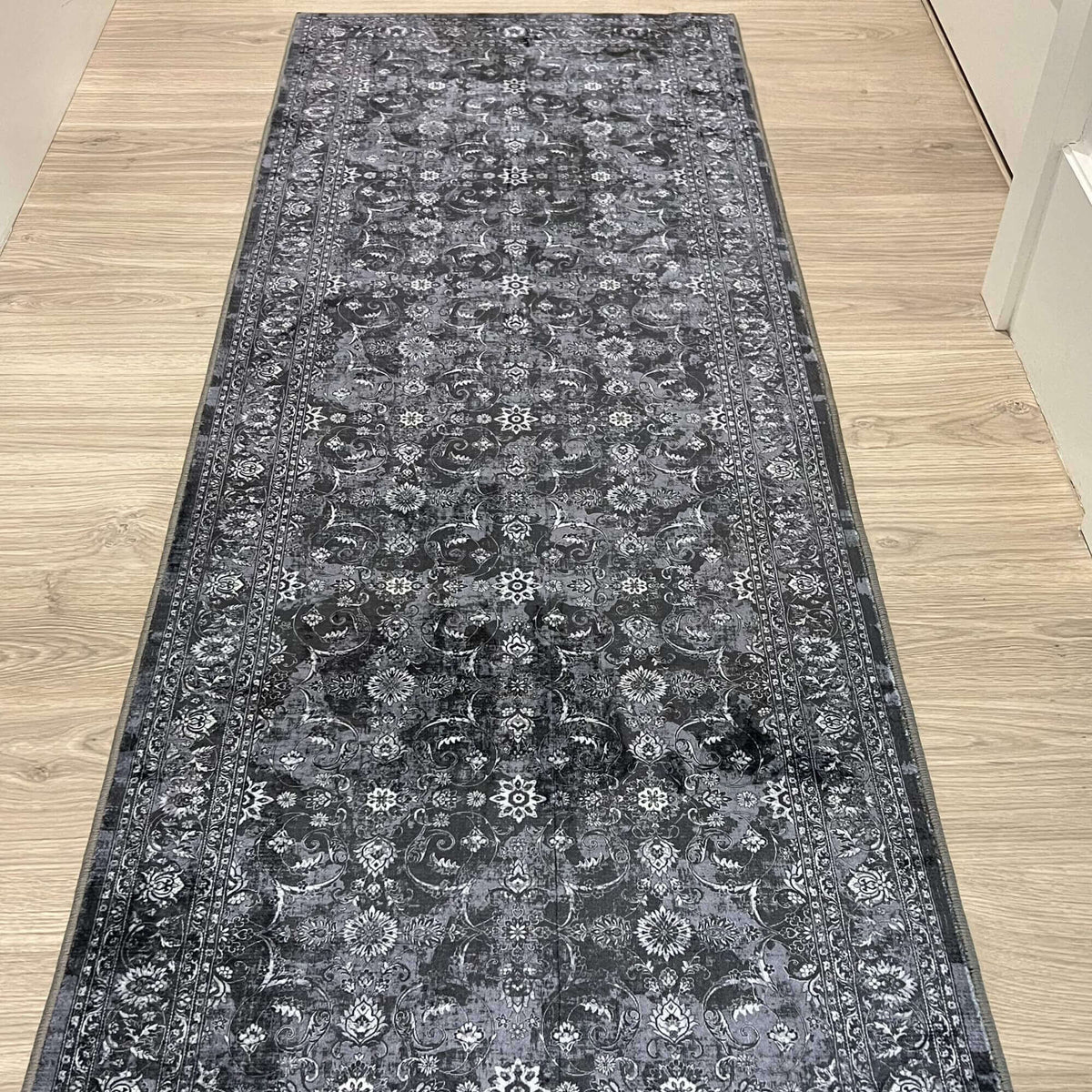 Elegant grey washable rug with intricate floral patterns, perfect for enhancing floor decor