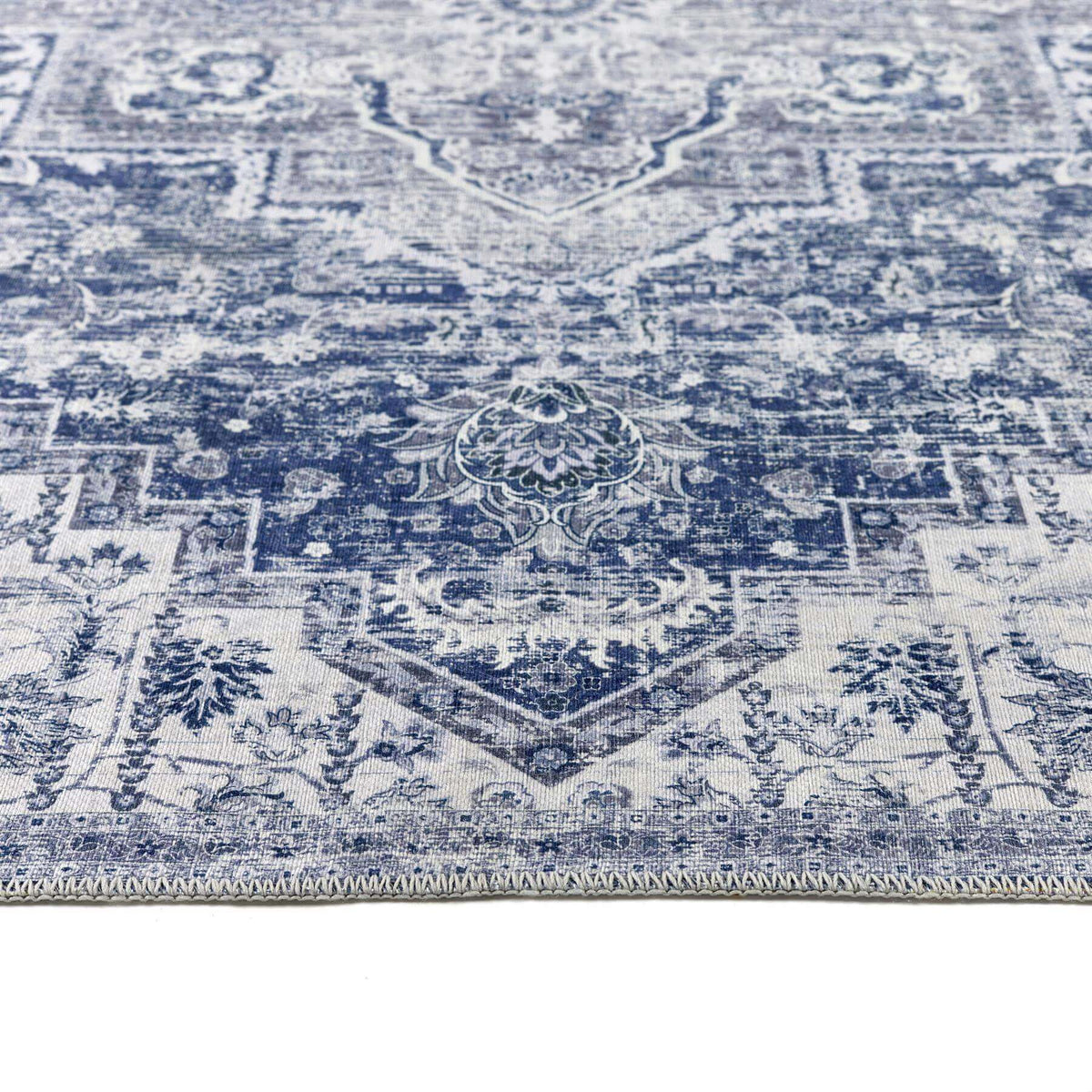 Elegant blue and white patterned washable rug featuring intricate designs for versatile home decor