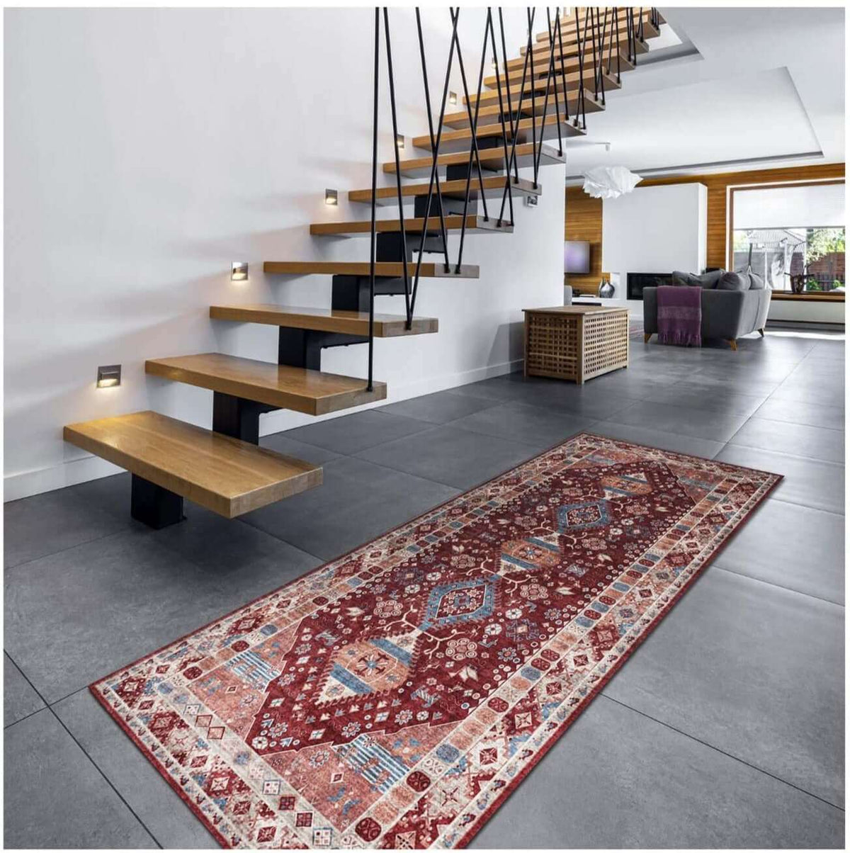 Traditional patterned washable rug placed beside modern stairs in a stylish living space