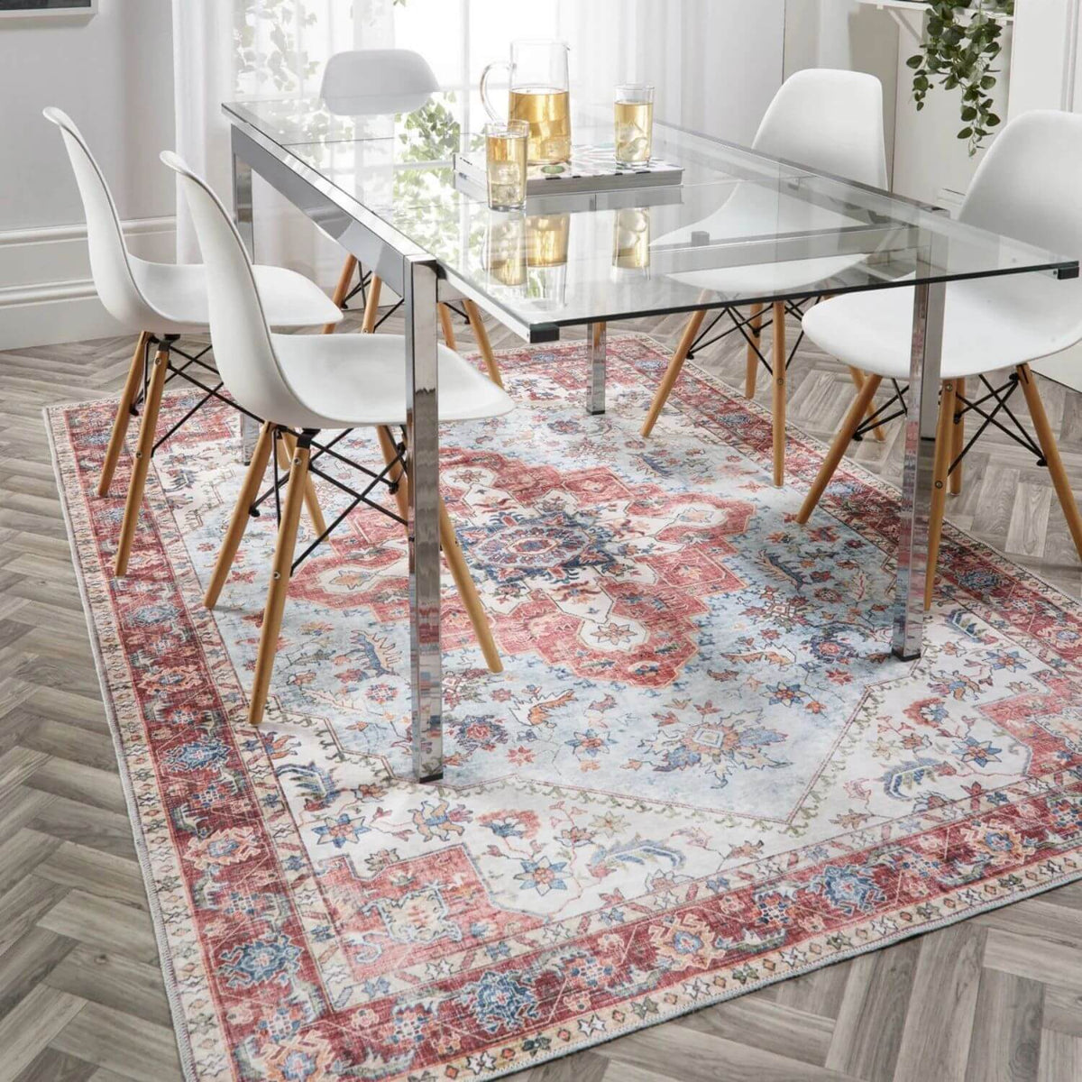 Elegant washable rug under glass dining table and chairs, adding warmth to the modern interior