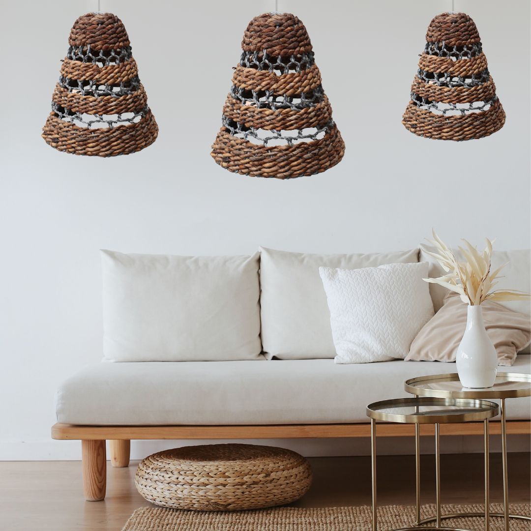 Natural Banana Leaf and Hitam Raffia Lamp Shades hanging above a modern sofa in a stylish living room